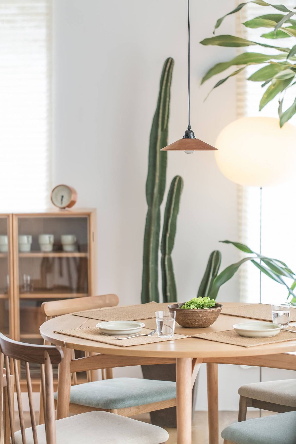 Light wood dining room with a round table