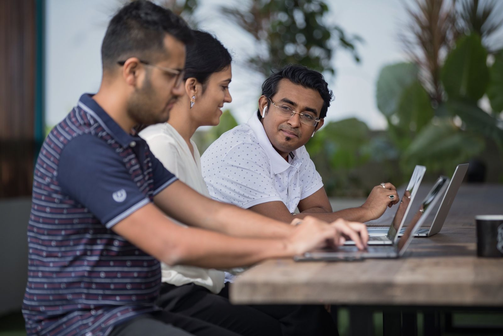 Colleagues working together at laptops in a bright office