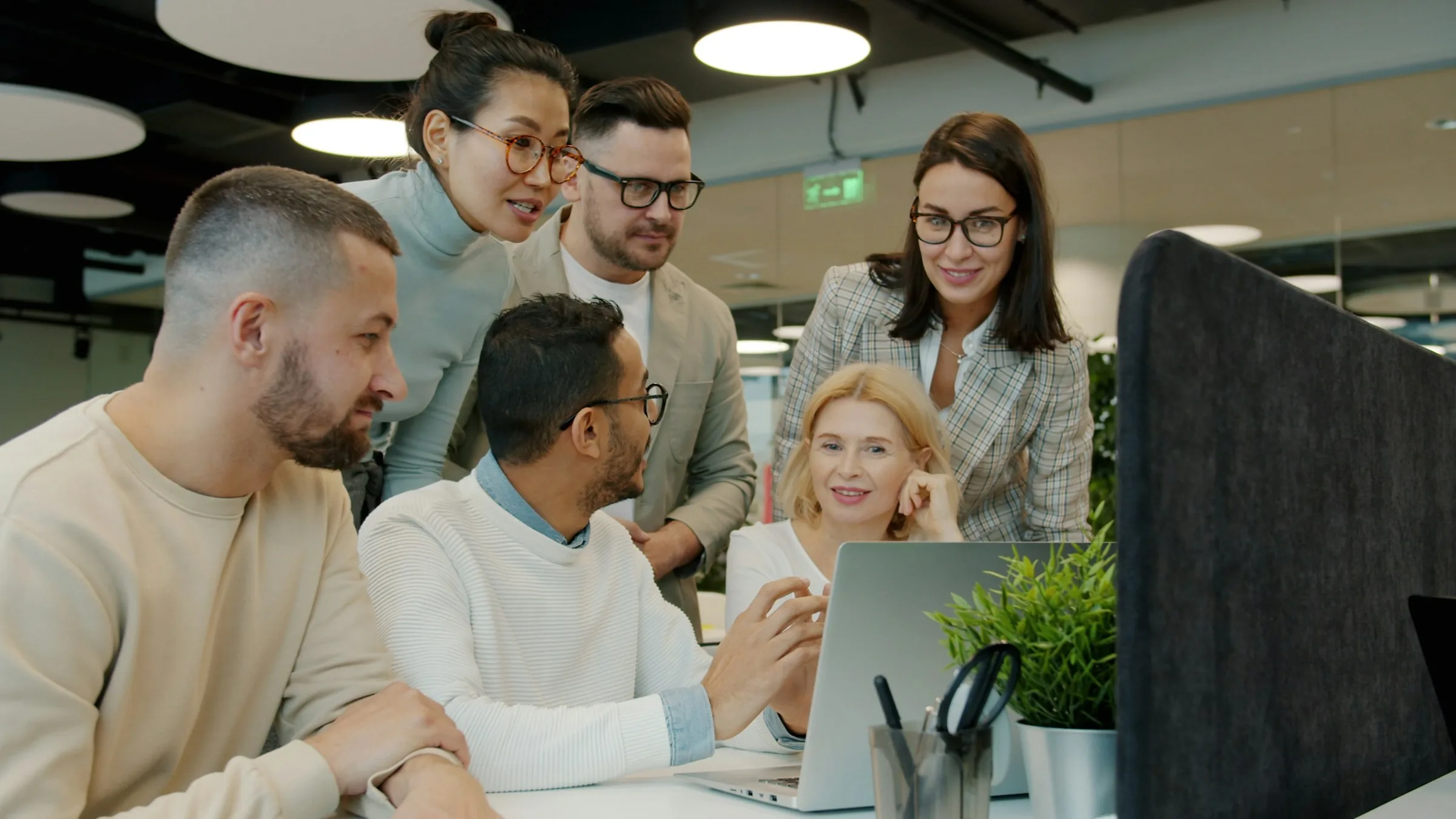 Creative team working together around a laptop