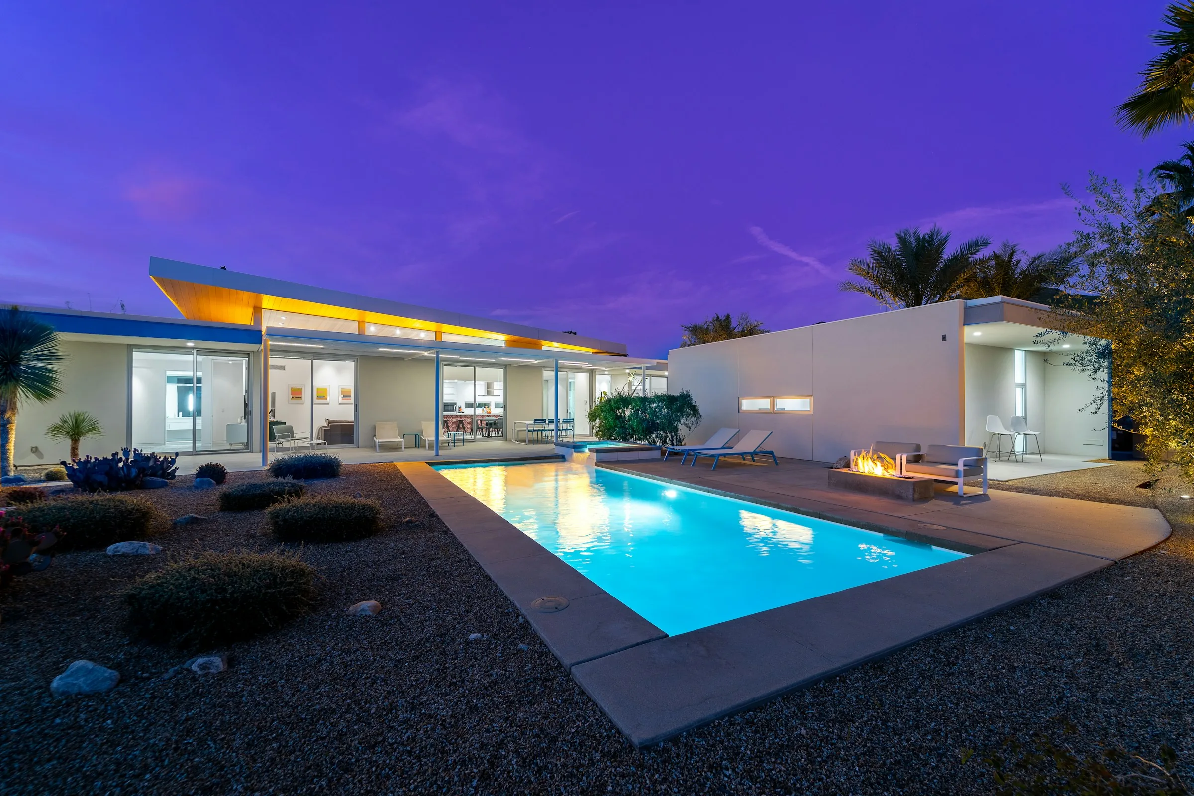 Modern two-storey villa with a pool at dusk