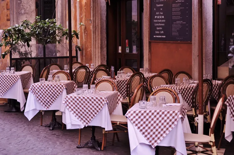 Tables with checked tablecloths on a street terrace