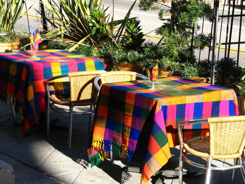 Bright tablecloths on a garden terrace