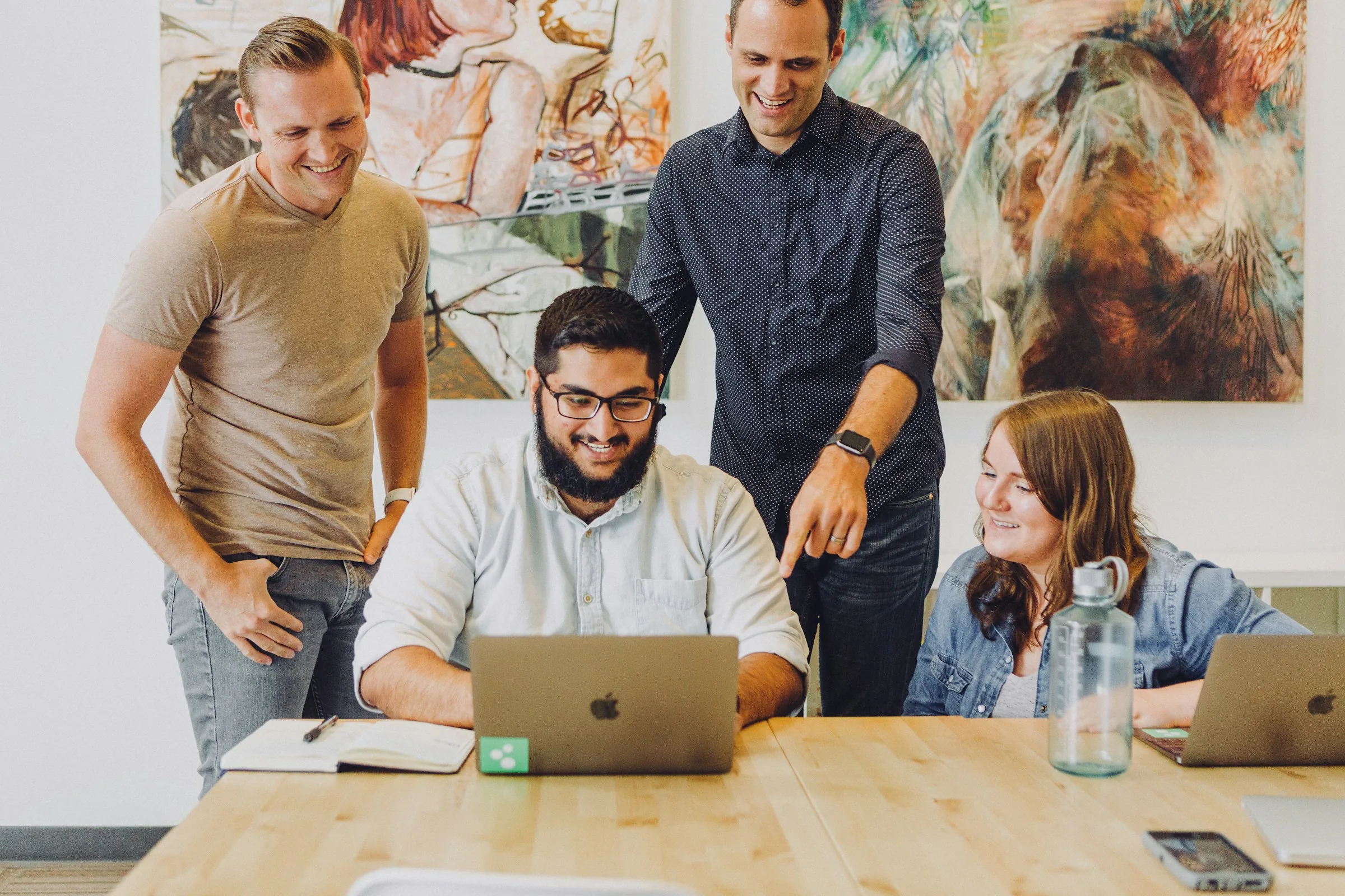 The Arshan team working together around a desk